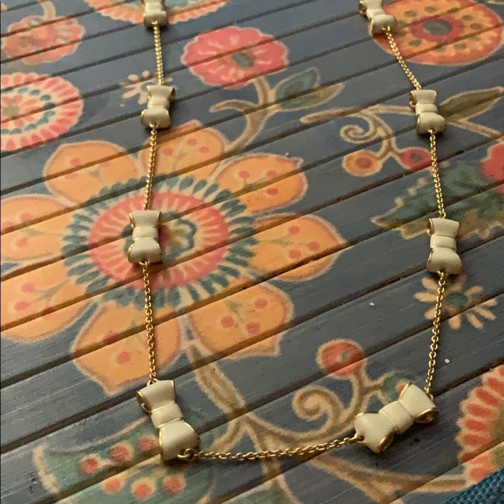 Kate Spade gold and ivory enamel bow long necklace